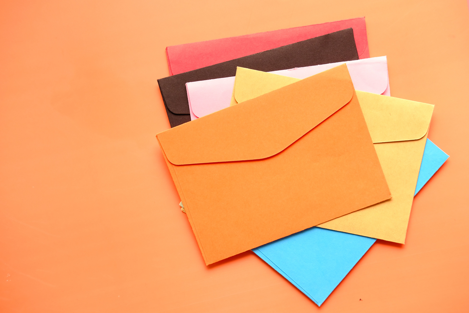 high angle view of colorful envelopes on white background
